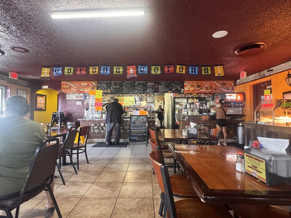A table with chips, salsa, and fresh dishes.