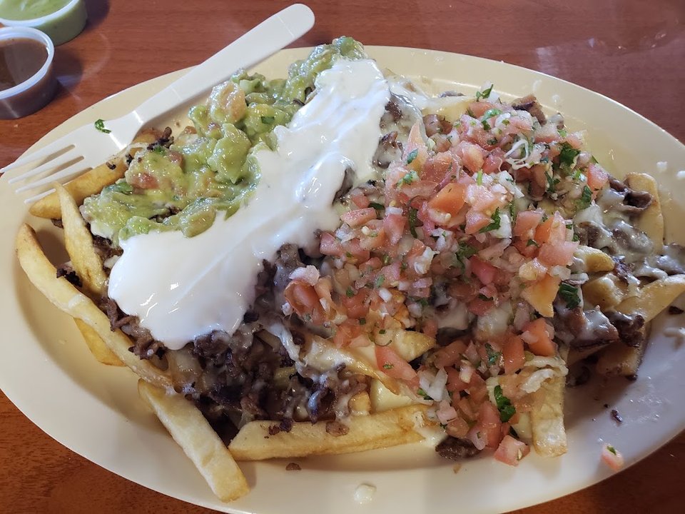 Taquería menu with sides and breakfast options.