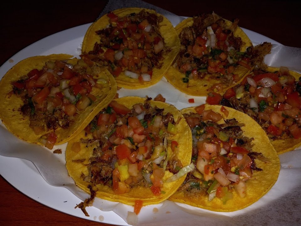 Breakfast plates and quesadillas listed on menu.